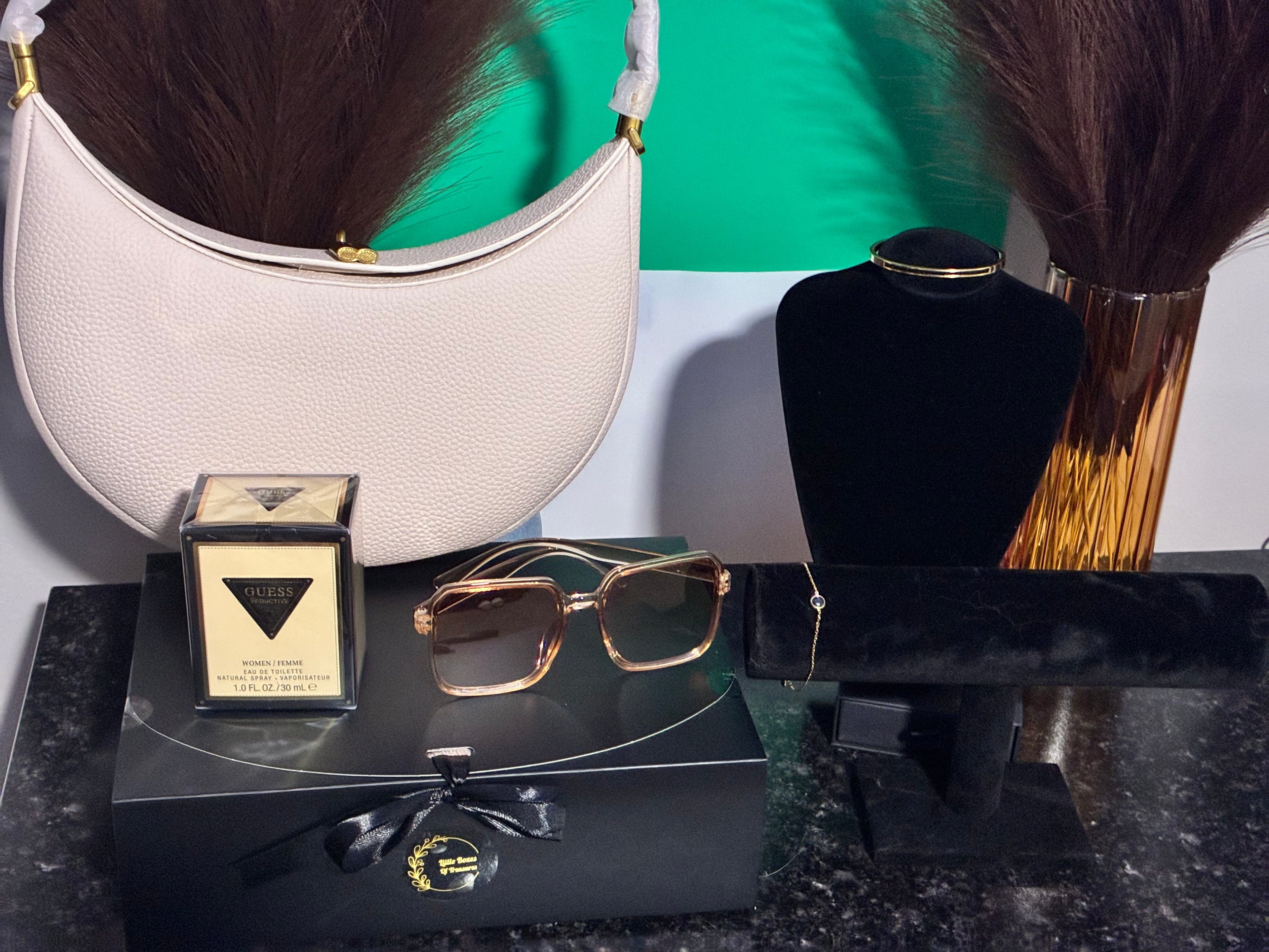cream leather handbag with adjustable strap perfume sunglasses two gold non-tarnishing bracelets